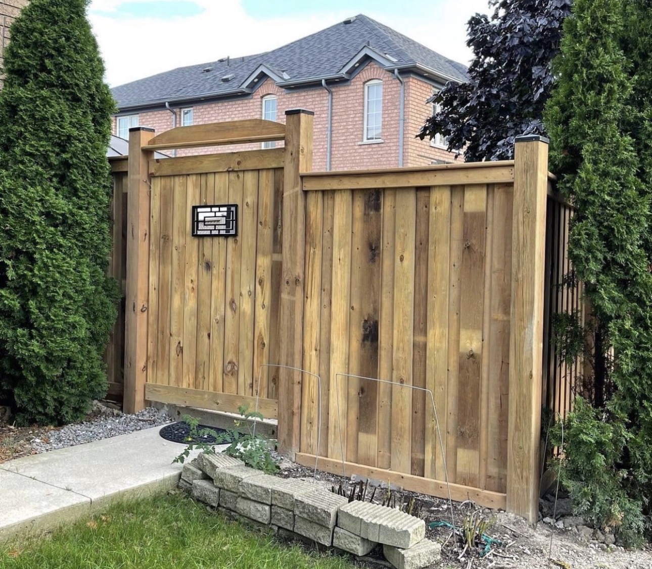 Wood privacy fence with an arched gate