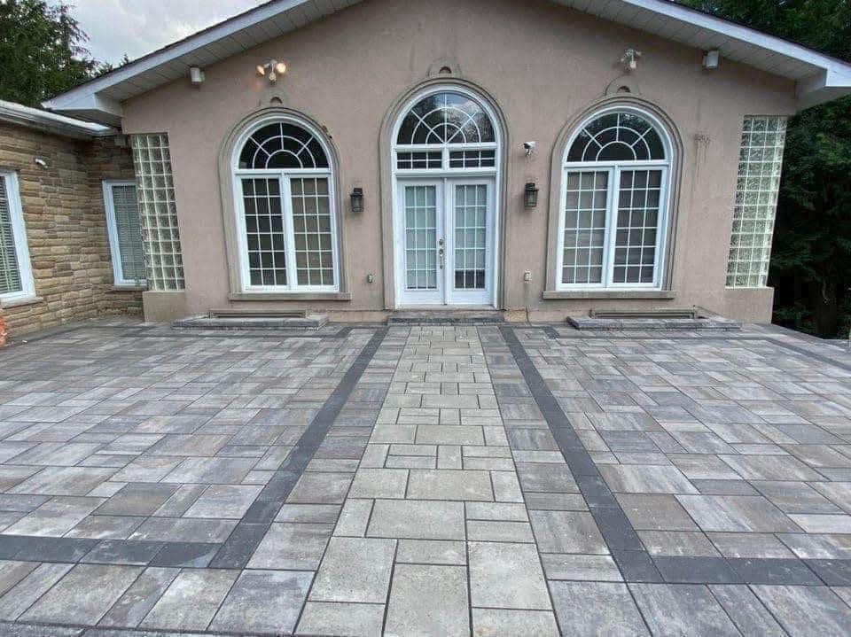 A wide patio with an inlaid walkway