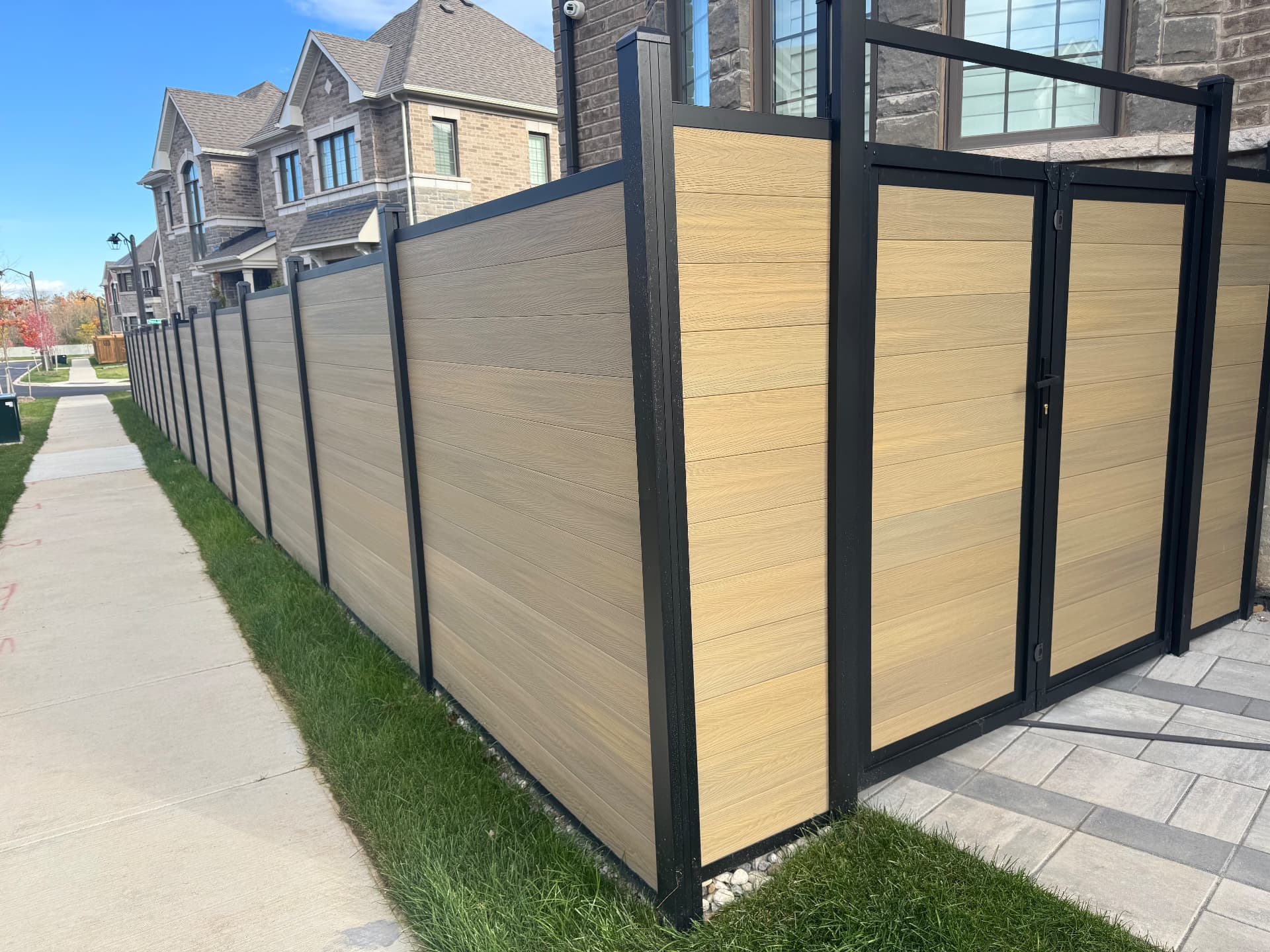 Modern composite fence with black framing
